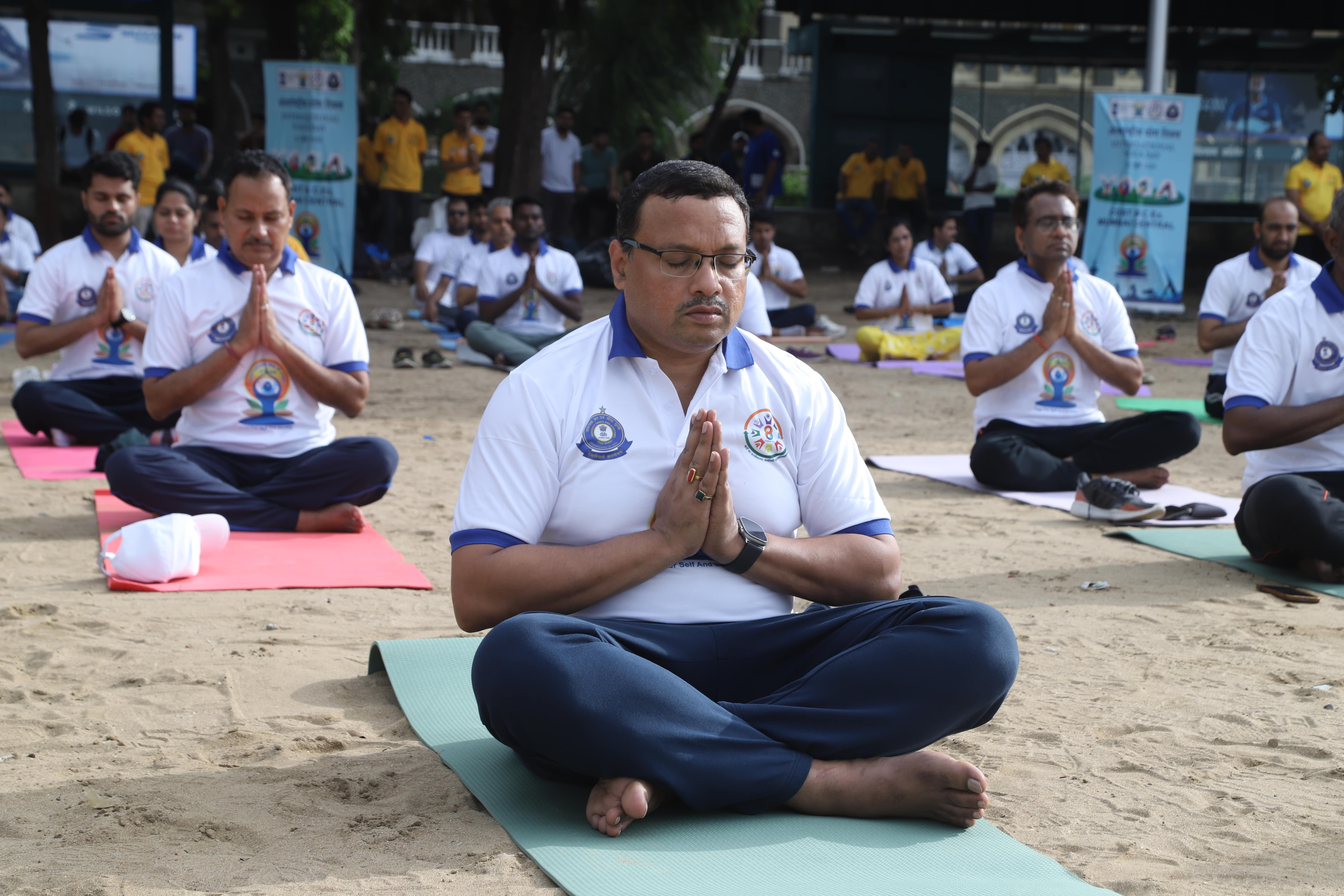 Department officers practicing yoga in a large hall